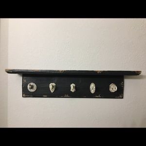 Distressed wooden shelf with hooks